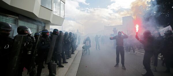 Hooded protesters face off with French riot police during a demonstration to mark the one-year anniversary of a protest march in 2014 which ended in clashes with riot police, in Nantes February 21, 2015. - Sputnik International