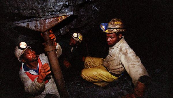 Miners work underground at the Harmony Goldmine, near Carletonville, South Africa, in this Wednesday Oct. 27, 2004 file photo. Some 3,000 miners were trapped underground when a water pipe burst and probably caused a shaft to collapse Wednesday, Oct. 3, 2007, in Harmony Gold's Elandsrand Mine near Johannesburg, South Africa's economic capital and gold-mining center - Sputnik International