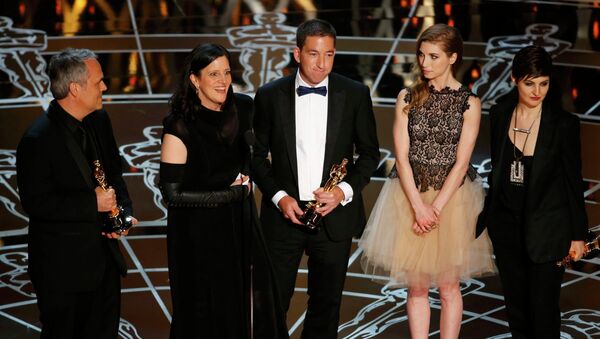 Laura Poitras (2nd L) speaks after accepting the Oscar along with colleagues for Best Documentary Feature for Citizenfour at the 87th Academy Awards in Hollywood, California February 22, 2015. - Sputnik International