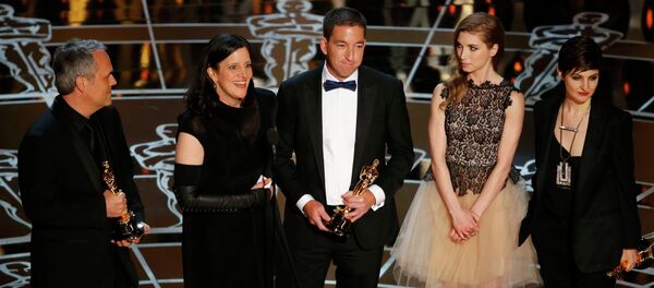 Laura Poitras (2nd L) speaks after accepting the Oscar along with colleagues for Best Documentary Feature for Citizenfour at the 87th Academy Awards in Hollywood, California February 22, 2015. - Sputnik International