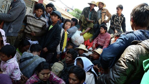 In this Feb. 17, 2015, photo provided by the Eleven Media Group, refugees wait for a Myanmar Red-Cross Team during a clash between government troops and Kokang rebels in Kokang, northeastern Shan State, more than 800 kilometers (500 miles) northeast of Yangon, Myanmar - Sputnik International