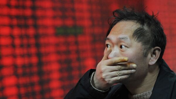 An investor gestures in front of a stock price board showing the red colour indicating rising prices at a private securities firm in Shanghai - Sputnik International