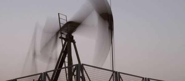 An oil pump jack works at sunset in the desert oil fields of Sakhir, Bahrain. An oil pump jack works at sunset in the desert oil fields of Sakhir, Bahrain. - Sputnik International
