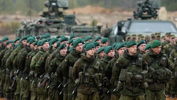 Lithuanian soldiers stand during a military exercise 'Iron Sword 2014' at the Gaiziunu Training Range in Pabrade some 60km.(38 miles) north of the capital Vilnius, Lithuania - Sputnik International