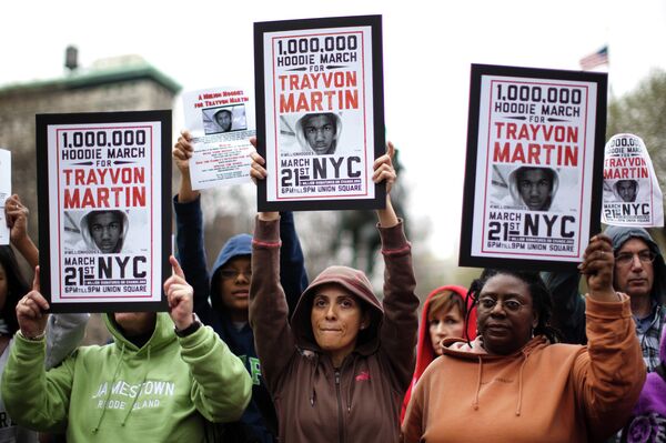 Demonstrators hold up signs during a rally for Trayvon Martin, Wednesday, March 21, 2012, in New York. - Sputnik International