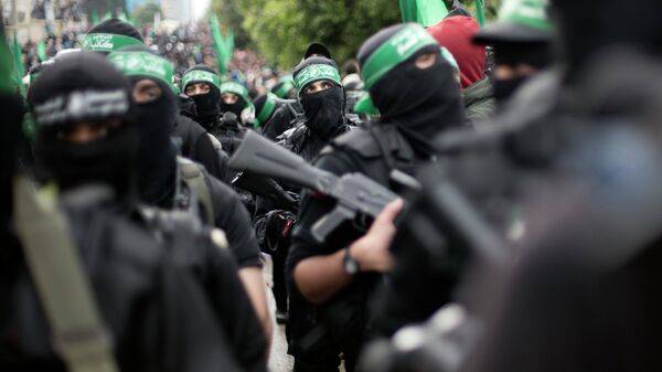 Palestinian Hamas masked gunmen display their military skills during a rally to commemorate the 27th anniversary of the Hamas militant group, in Gaza City, Sunday, Dec. 14, 2014 - Sputnik International