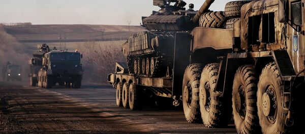 Military trucks from the Ukrainian armed forces transport tanks on the road near Artemivsk, eastern Ukraine, February 24, 2015 Military trucks from the Ukrainian armed forces transport tanks on the road near Artemivsk, eastern Ukraine, February 24, 2015 - Sputnik International