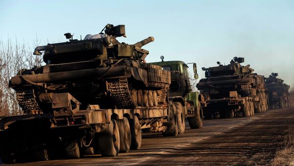 Military trucks from the Ukrainian armed forces transport tanks on the road near Artemivsk, eastern Ukraine, February 24, 2015 - Sputnik International