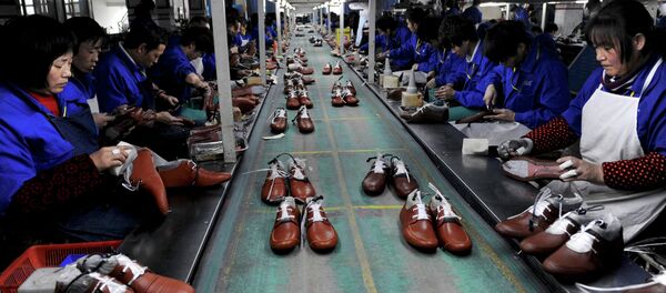 The strengthening dollar and the imbalances in international trade it invoked have become the main source of turbulence for the developing nations. Above: Employees work at a shoe factory in Lishui, Zhejiang province. - Sputnik International
