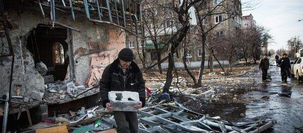 A man salvages cinder blocks from a destroyed building on February 25, 2015 in Debaltseve, Ukraine A man salvages cinder blocks from a destroyed building on February 25, 2015 in Debaltseve, Ukraine - Sputnik International