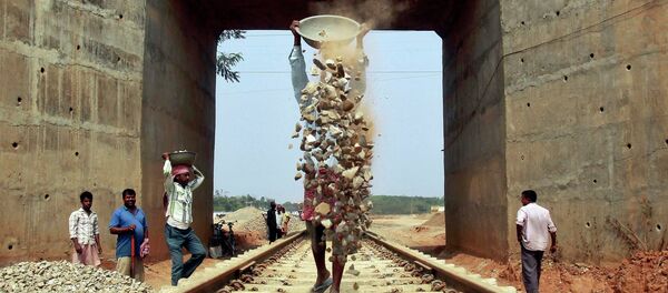 Labourers work at the installation site of a new railway track on the outskirts of Agartala, capital of India's northeastern state of Tripura February 25, 2015 - Sputnik International