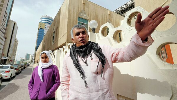 Human rights activist Nabeel Rajab (R) gestures as he walks with his daughter Malak Rajab to attend his appeal hearing at court in Manama, February 11, 2015 - Sputnik International