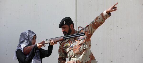 Pakistan Rangers soldier gestures as he instructs a female student of Nadirshaw Eduljee Dinshaw (NED) University during a counter-terrorism training demonstration at the Rangers Shooting & Saddle Club (RSSC) on the outskirts of Karachi, February 24, 2015 Pakistan Rangers soldier gestures as he instructs a female student of Nadirshaw Eduljee Dinshaw (NED) University during a counter-terrorism training demonstration at the Rangers Shooting & Saddle Club (RSSC) on the outskirts of Karachi, February 24, 2015 - Sputnik International