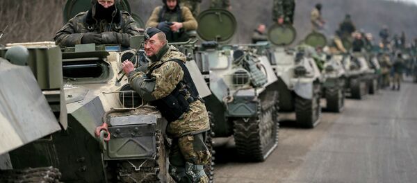 Members of the Ukrainian armed forces and armoured personnel carriers are seen preparing to move as they pull back from Debaltseve region, near Artemivsk - Sputnik International