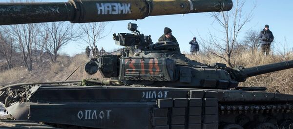 A tank crew member of the self-proclaimed Donetsk People's Republic Army sits on top of a tank at a checkpoint on the road from the town of Vuhlehirsk to Debaltseve A tank crew member of the self-proclaimed Donetsk People's Republic Army sits on top of a tank at a checkpoint on the road from the town of Vuhlehirsk to Debaltseve - Sputnik International