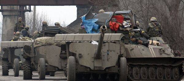 Ukrainian Armoured Personnel Carriers move cannons from their position near eastern Ukrainian city of Artemivsk, in the Donetsk region Ukrainian Armoured Personnel Carriers move cannons from their position near eastern Ukrainian city of Artemivsk, in the Donetsk region - Sputnik International