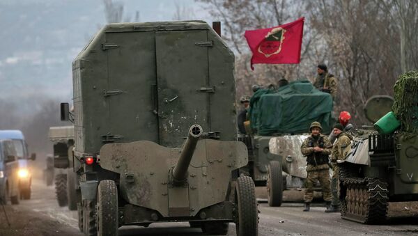 A convoy of Ukrainian armed forces including armoured personnel carriers, military vehicles and cannons prepare to move as they pull back from the Debaltseve region, in Paraskoviyvka, eastern Ukraine - Sputnik International