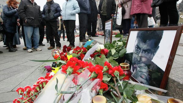 Photos, flowers and candles are left in memory of Boris Nemtsov, who was recently murdered in Moscow, in Independence Square in Kiev, February 28, 2015. - Sputnik International