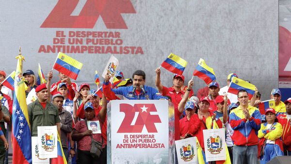 Venezuela's President Nicolas Maduro (C) speaks during a rally to commemorate the 26th anniversary of the social uprising known as 'Caracazo', which Venezuela's late President Hugo Chavez said marked the start of his revolution, in Caracas in this February 28, 2015 picture provided by Miraflores Palace. - Sputnik International