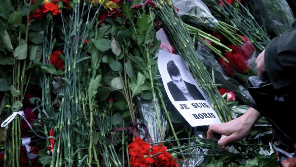 People place flowers on February 28, 2015 at the spot, where Russian opposition leader Boris Nemtsov was shot dead, near Saint-Basil's Cathedral, in the center of Moscow - Sputnik International
