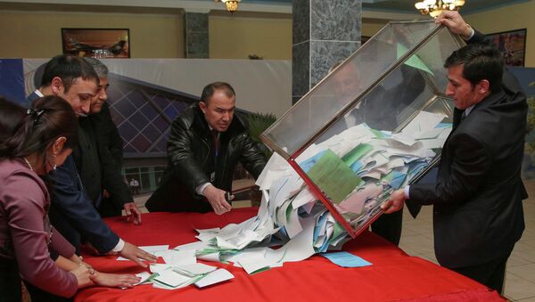 A member of a local electoral commission empties a ballot box after a parliamentary election at a polling station in the Tajik capital Dushanbe - Sputnik International