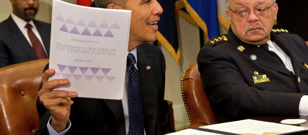 Philadelphia Police Commissioner Charles Ramsey watches at right as President Barack Obama holds up a copy of the interim report of the President's Task Force on 21st Century Policing. Philadelphia Police Commissioner Charles Ramsey watches at right as President Barack Obama holds up a copy of the interim report of the President's Task Force on 21st Century Policing. - Sputnik International