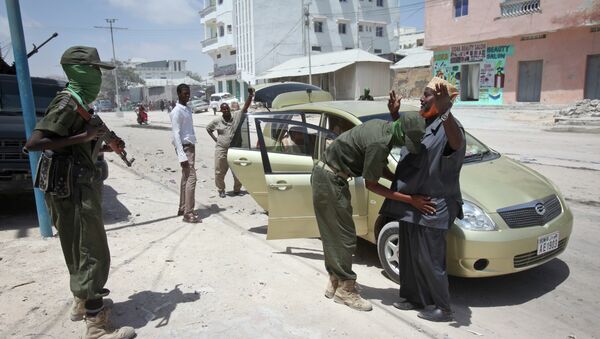 A man is questioned and searched during random vehicle check as part of an operation by Somali security forces against suspected members of the militant group al-Shabab in the capital Mogadishu, Somalia. File photo - Sputnik International