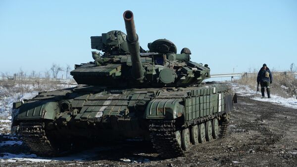 A self-defender of the Lugansk People's Republic near a captured T-64 tank in Debaltsevo. - Sputnik International