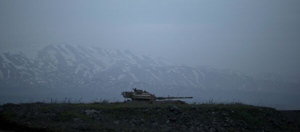 An old Israeli tank sits in a position in the Israeli-controlled Golan Heights near the border with Syria - Sputnik International