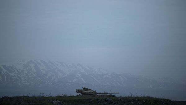 An old Israeli tank sits in a position in the Israeli-controlled Golan Heights near the border with Syria - Sputnik International