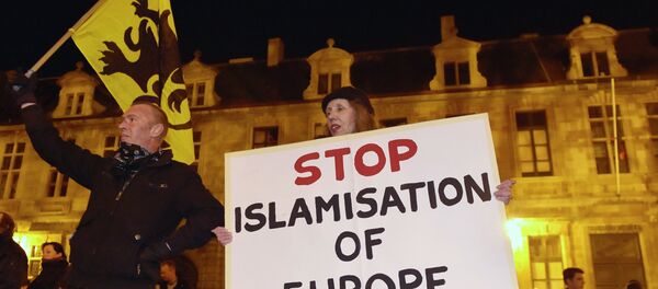 Members of the Belgian branch of Germany's anti-Islam group, PEGIDA (Patriotic Europeans Against the Islamisation of the West), take part in a demonstration in Antwerp - Sputnik International
