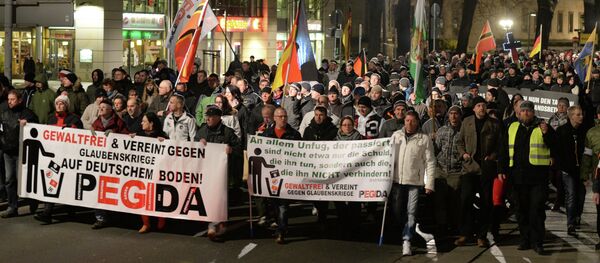 People march during a demonstration of the socalled movement of Patriotic Europeans Against the Islamisation of the Occident aka Pegida, in Dresden People march during a demonstration of the socalled movement of Patriotic Europeans Against the Islamisation of the Occident aka Pegida, in Dresden - Sputnik International