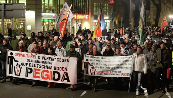 People march during a demonstration of the socalled movement of Patriotic Europeans Against the Islamisation of the Occident aka Pegida, in Dresden - Sputnik International