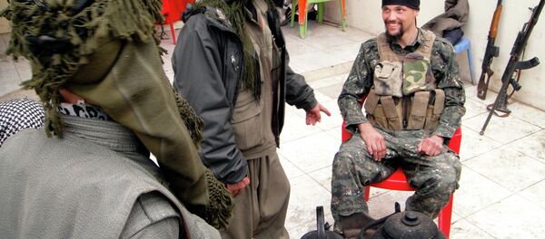 In this Thursday, Jan. 29, 2015 photo, Jordan Matson, 28, right, a former U.S. Army soldier from Sturtevant, Wis., takes a break with other fighters from the main Kurdish militia, the People's Protection Units, or YPG, in Sinjar, Iraq In this Thursday, Jan. 29, 2015 photo, Jordan Matson, 28, right, a former U.S. Army soldier from Sturtevant, Wis., takes a break with other fighters from the main Kurdish militia, the People's Protection Units, or YPG, in Sinjar, Iraq - Sputnik International