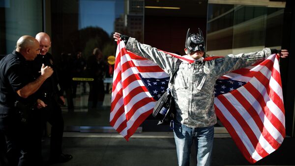A man dressed as Batman protests against the killing of a homeless man by police outside LAPD headquarters in Los Angeles, California March 3, 2015 - Sputnik International
