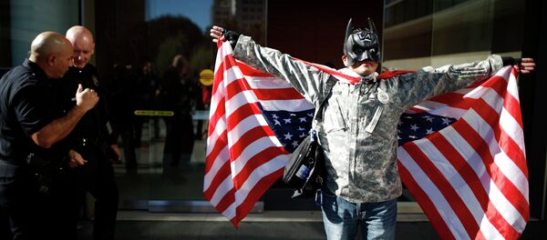 A man dressed as Batman protests against the killing of a homeless man by police outside LAPD headquarters in Los Angeles, California March 3, 2015 - Sputnik International