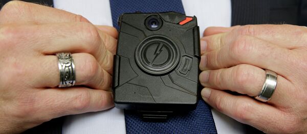 Feb. 19, 2015, Steve Tuttle, vice president of communications for Taser International, demonstrates one of the company's body cameras - Sputnik International