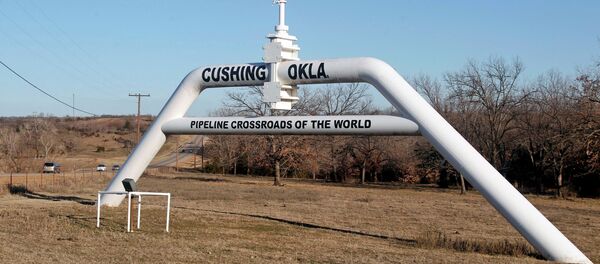 This Wednesday, Feb. 1, 2012 photo shows a marker declaring Cushing, Okla. as the pipeline crossroads of the world, in Cushing. For the past seven weeks, the United States has been producing and importing an average of 1 million more barrels of oil every day than it is consuming. This Wednesday, Feb. 1, 2012 photo shows a marker declaring Cushing, Okla. as the pipeline crossroads of the world, in Cushing. For the past seven weeks, the United States has been producing and importing an average of 1 million more barrels of oil every day than it is consuming. - Sputnik International