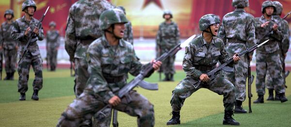 Chinese People's Liberation Army cadets shout as they take part in a bayonet drills at the PLA's Armoured Forces Engineering Academy Base, on the outskirt of Beijing, China Chinese People's Liberation Army cadets shout as they take part in a bayonet drills at the PLA's Armoured Forces Engineering Academy Base, on the outskirt of Beijing, China - Sputnik International