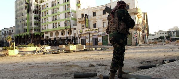 A Libyan soldier, loyal to Libya's internationally recognised government of Abdullah al-Thani and General Khalifa Haftar, patrols a street in the eastern coastal city of Benghazi on February 28, 2015 A Libyan soldier, loyal to Libya's internationally recognised government of Abdullah al-Thani and General Khalifa Haftar, patrols a street in the eastern coastal city of Benghazi on February 28, 2015 - Sputnik International