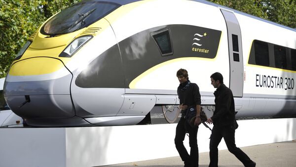 Pedestrians walk by a mock up of an Eurostar 320 high speed train in central London - Sputnik International