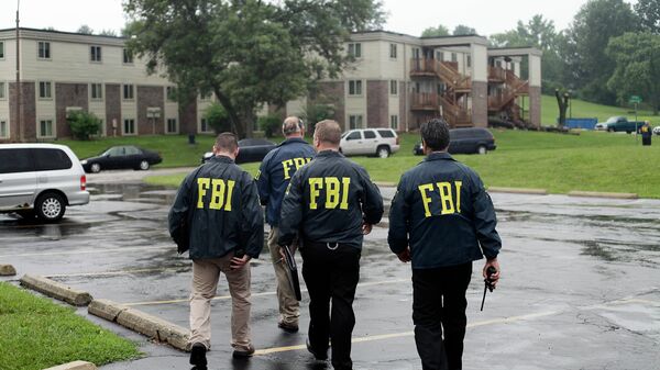 FBI Agents on August 16, 2014, investigate the shooting death of 18-year-old Michael Brown at the location where he was killed on Canfield Drive in Ferguson, Missouri - Sputnik International