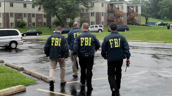 FBI Agents on August 16, 2014, investigate the shooting death of 18-year-old Michael Brown at the location where he was killed on Canfield Drive in Ferguson, Missouri - Sputnik International