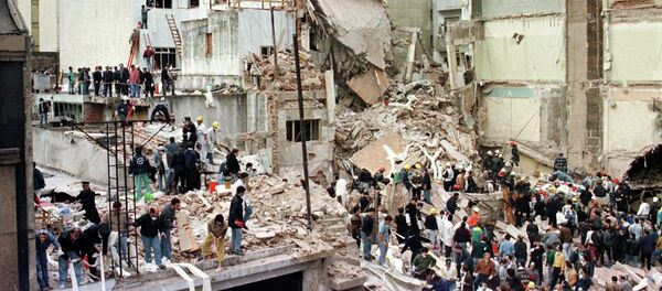 Rescue workers search for survivors and victims in the rubble after a powerful car bomb destroyed the Buenos Aires headquarters of the Argentine Israelite Mutual Association (AMIA), in this July 18, 1994 file photo - Sputnik International