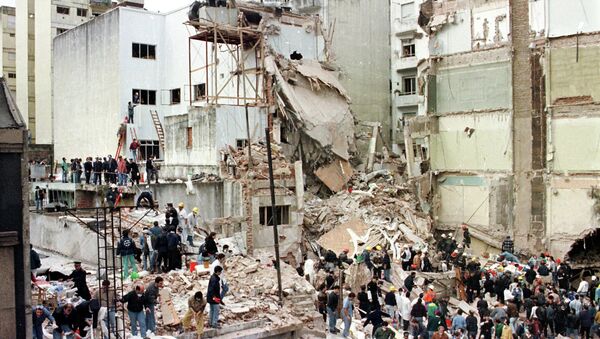 Rescue workers search for survivors and victims in the rubble after a powerful car bomb destroyed the Buenos Aires headquarters of the Argentine Israelite Mutual Association (AMIA), in this July 18, 1994 file photo - Sputnik International