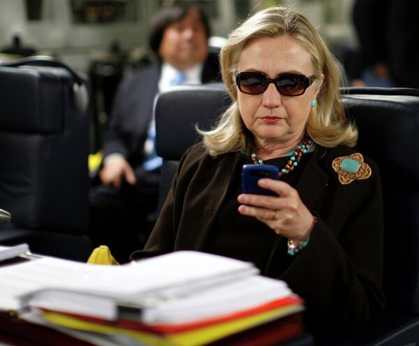 Former US Secretary of State Hillary Clinton checks her PDA upon her departure in a military C-17 plane from Malta bound for Tripoli, Libya, in this October 18, 2011, file photo Former US Secretary of State Hillary Clinton checks her PDA upon her departure in a military C-17 plane from Malta bound for Tripoli, Libya, in this October 18, 2011, file photo - Sputnik International