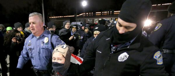Ferguson, Mo., police officers take into custody a protester who was warned several times not to block the street outside the police station Ferguson, Mo., police officers take into custody a protester who was warned several times not to block the street outside the police station - Sputnik International