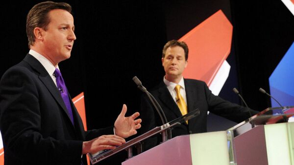 Conservative leader David Cameron, left, and Liberal Democrat Party leader Nick Clegg, centre, take part in Britain's second televised election debate in Bristol, England, Thursday, April 22, 2010. - Sputnik International