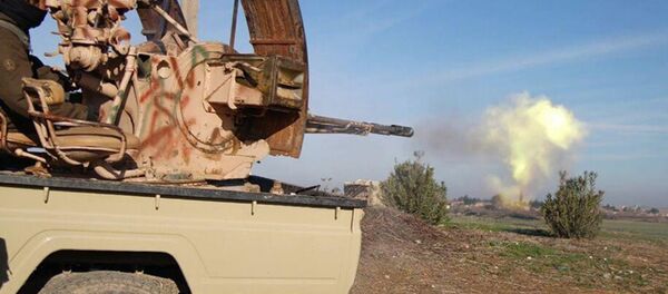 In this image posted on a militant social media account by the Al-Baraka division of the Islamic State group on Tuesday, Feb. 24, 2015, a fighter fires a heavy weapon mounted on the back of a pickup truck during fighting in Tal Tamr, Hassakeh province, Syria In this image posted on a militant social media account by the Al-Baraka division of the Islamic State group on Tuesday, Feb. 24, 2015, a fighter fires a heavy weapon mounted on the back of a pickup truck during fighting in Tal Tamr, Hassakeh province, Syria - Sputnik International