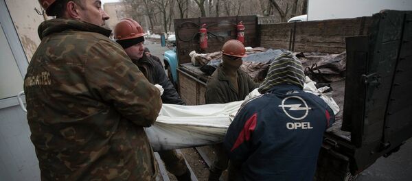 Miners carry a covered body of one of their co-workers killed by a blast at the Zasyadko coal mine into a morgue in Donetsk March 5, 2015 Miners carry a covered body of one of their co-workers killed by a blast at the Zasyadko coal mine into a morgue in Donetsk March 5, 2015 - Sputnik International